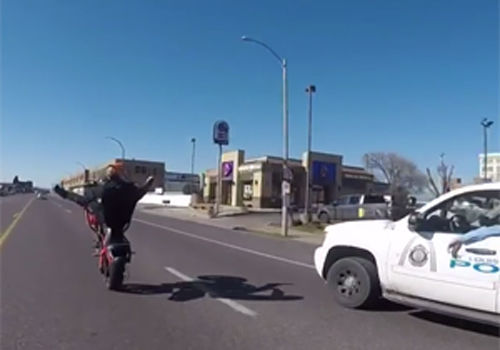 Motorcyclist performs stunt in front of St. Louis police officer